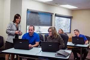 Instructor helping students learn Microsoft 365